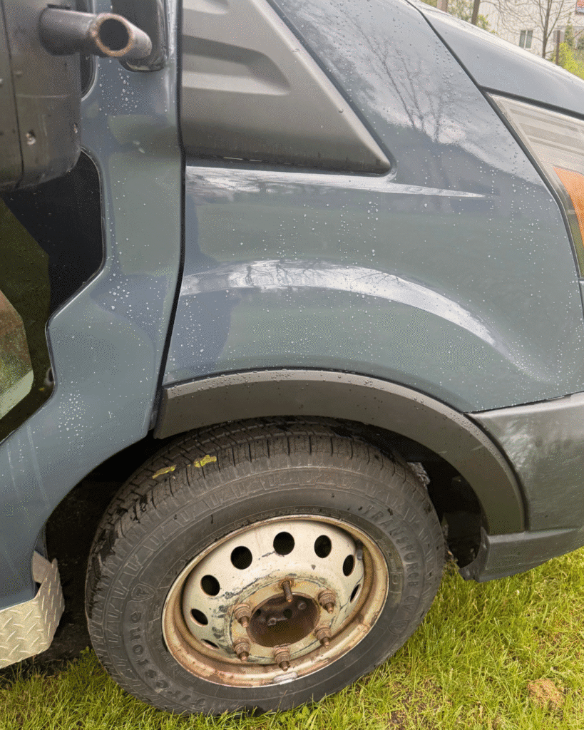 A blue 2024 Ford transit 2500 high roof is newly repaired, and no longer shows signs of damage on the right side