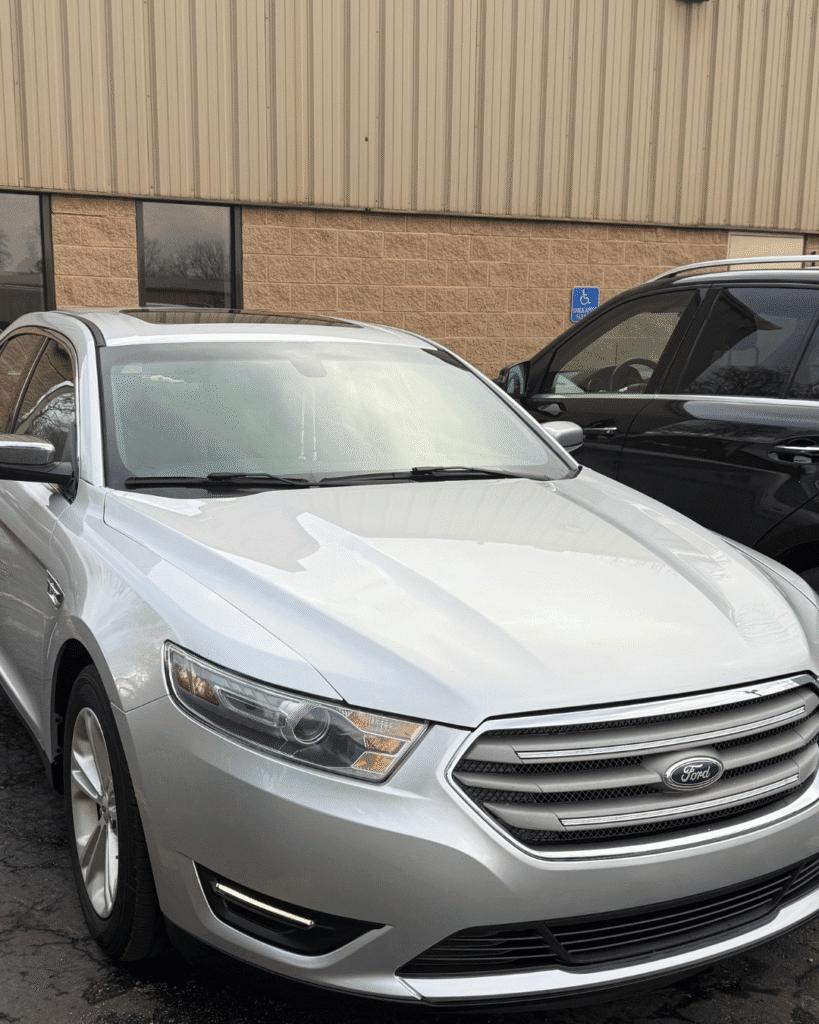 A white Ford Taurus had its left side repaired by our team, and shines with a new brilliance.