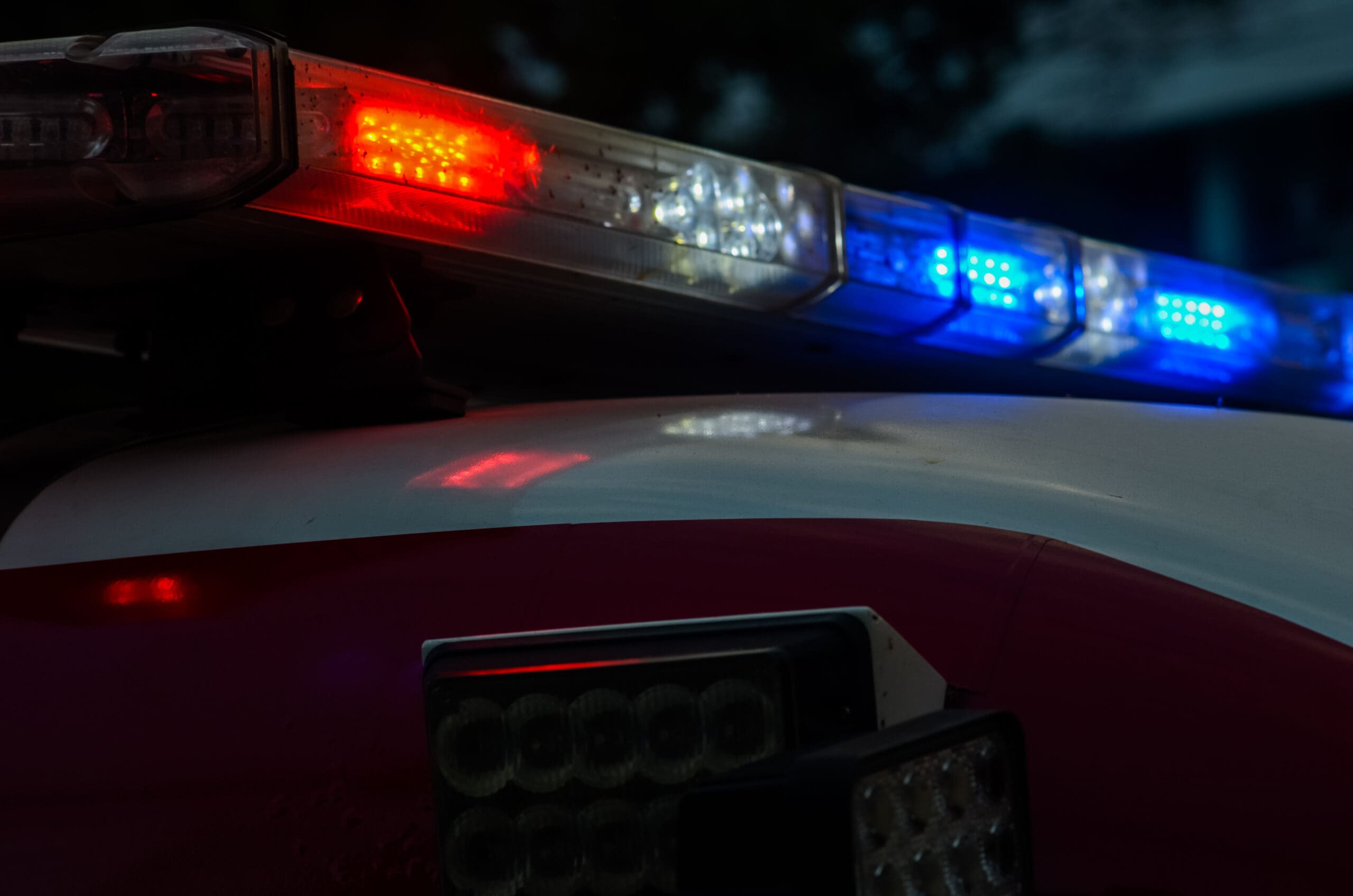 Police vehicle's top with lights on.